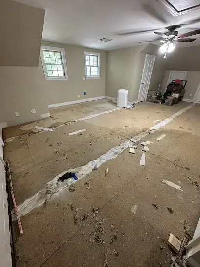 An empty room with the flooring pulled up after a water loss