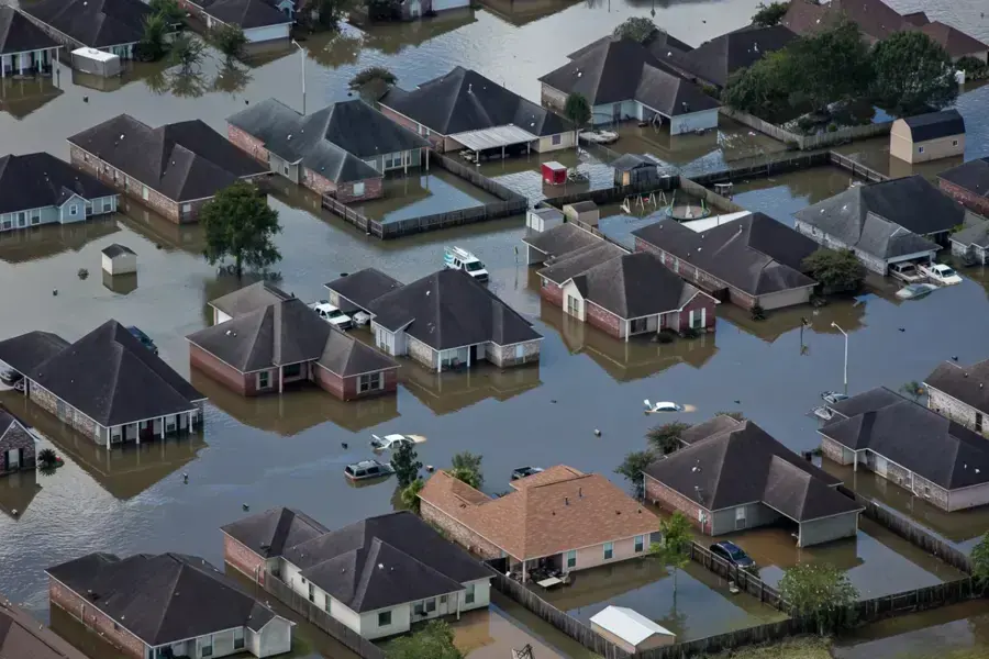 Aerial view of a flooded Louisiana subdivision with water around the houses after heavy rain