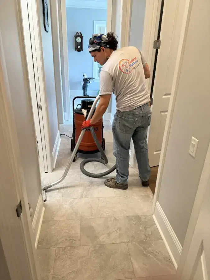 Technician extracting water from a hallway floor, shown for Harahan water damage cleanup
