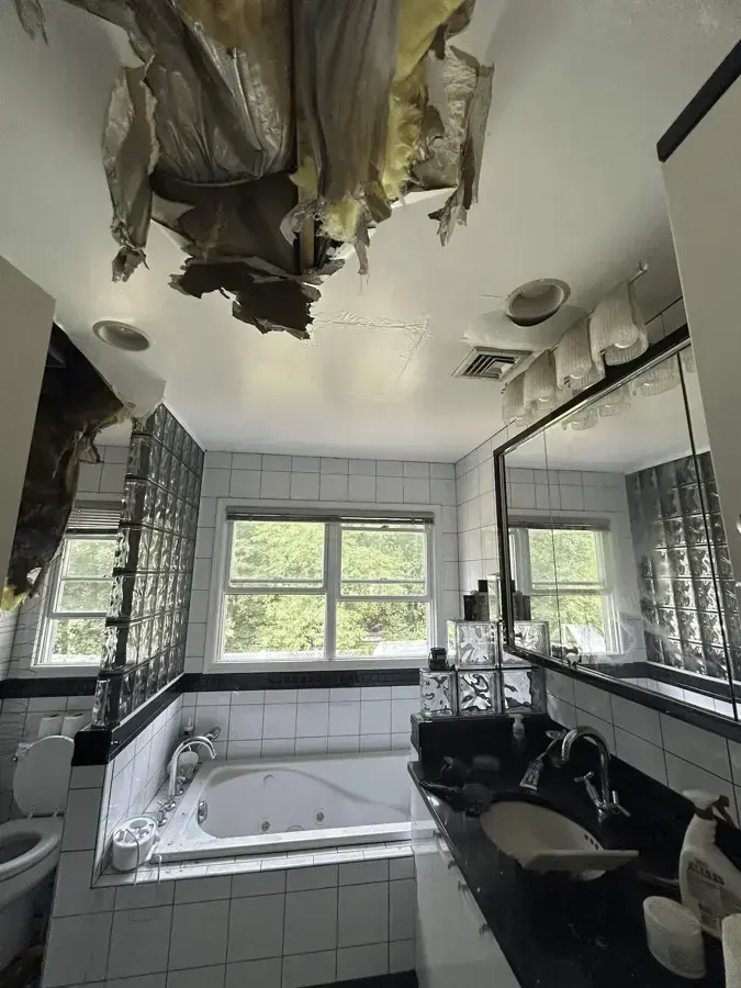A bathroom ceiling collapsed after water from a pipe above soaked through