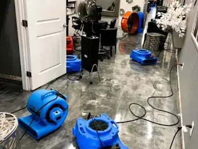 Air movers drying the wet floor of a salon with chairs and stations behind them